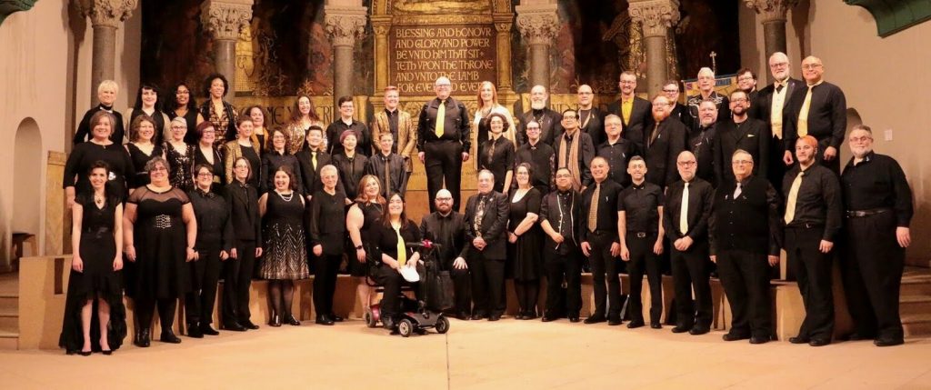 Formal choir of singers dressed in black dresses and tuxedoes