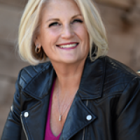 headshot of Carol Paskulin, smiling white woman with shoulder-length blonde hair