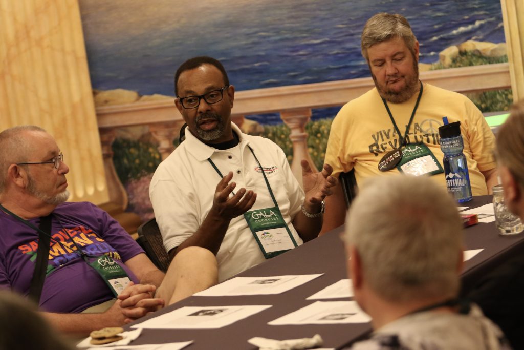 A group of delegates talk around a table at Festival 2016.