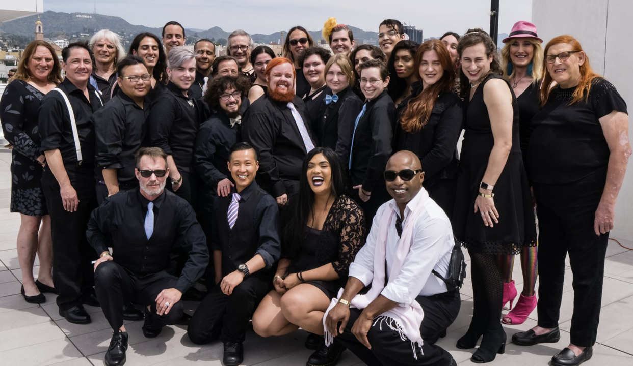 group of trans men and women laughing and smiling