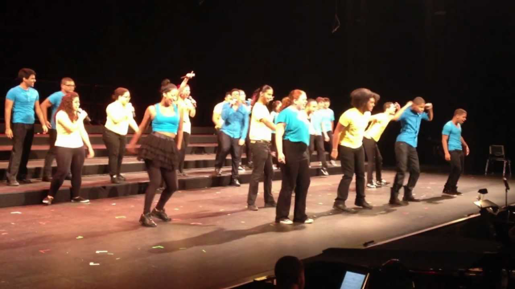 A youth chorus performs on a stage