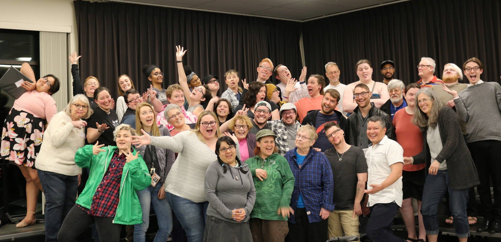 A group of people pose for a picture some with silly faces