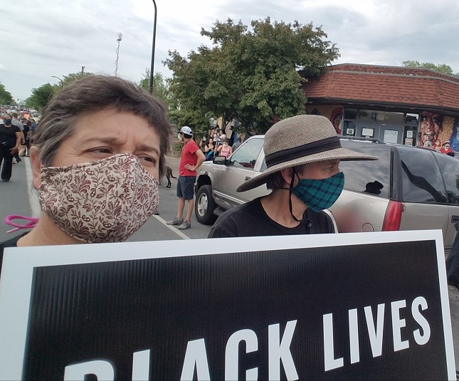 A group of protestors hold a Black Lives Matter sign