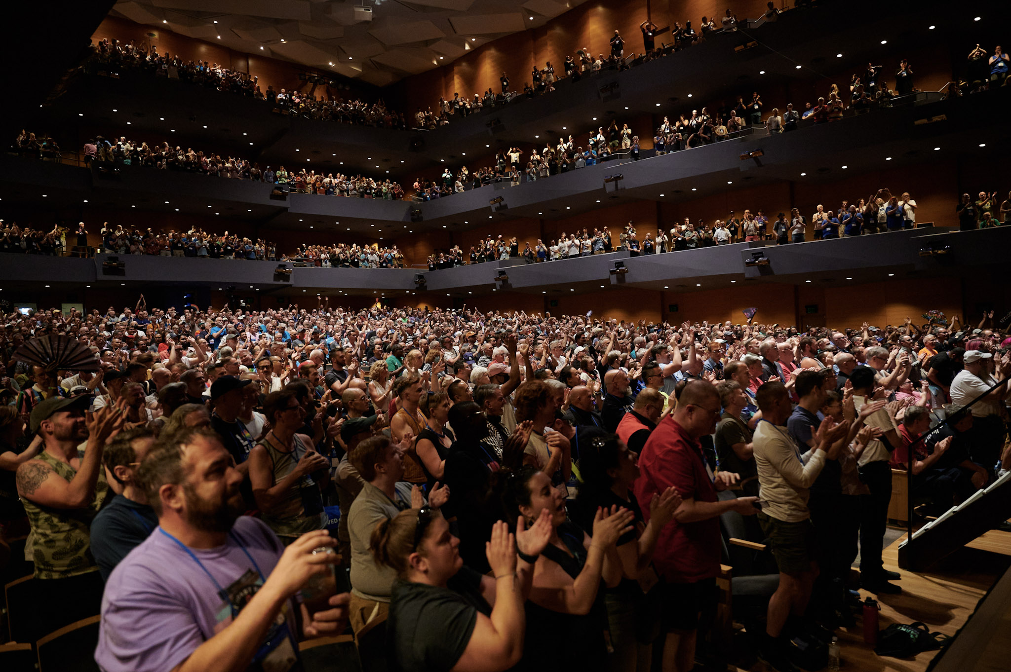 An audience filled with Festival 2024 delegates in Orchestra Hall in Minneapolis stands and applauds.