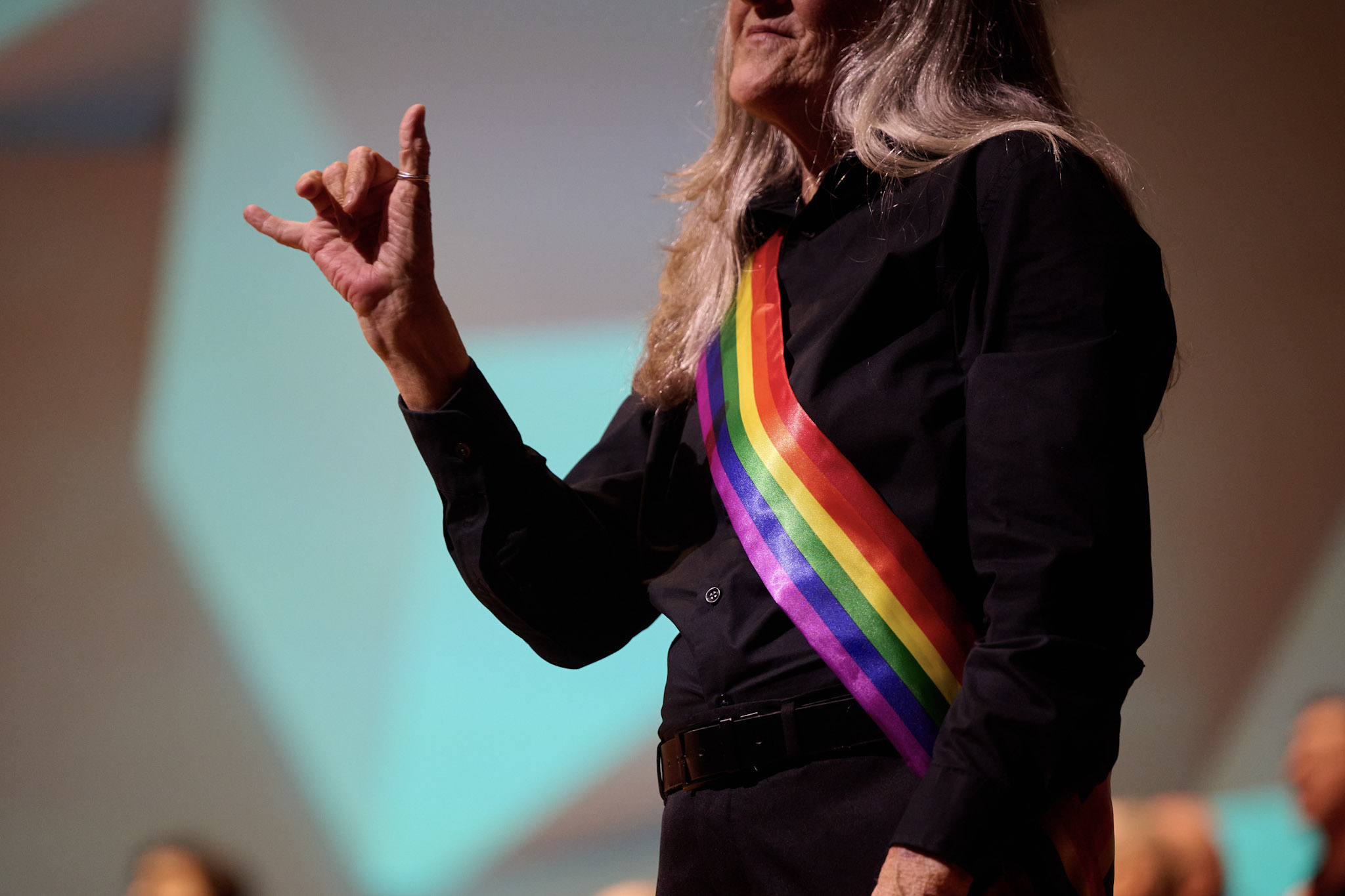 An ASL interpreter signs "I love you" at Festival 2024.