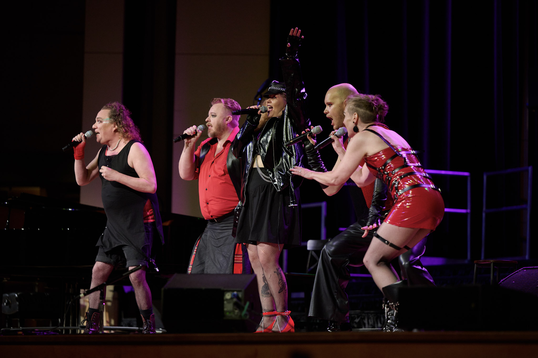 A small ensemble wearing read and black sings at Festival 2024.