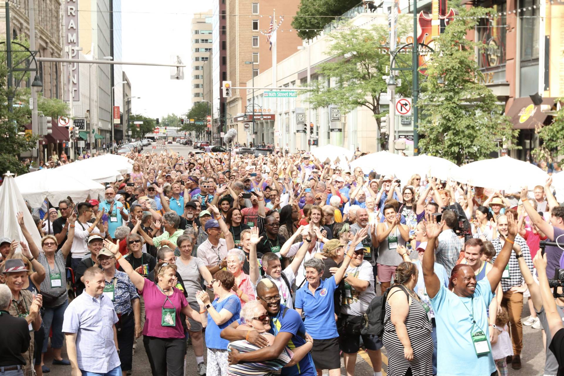 Many festival singers are celebrating in the street with raised hands