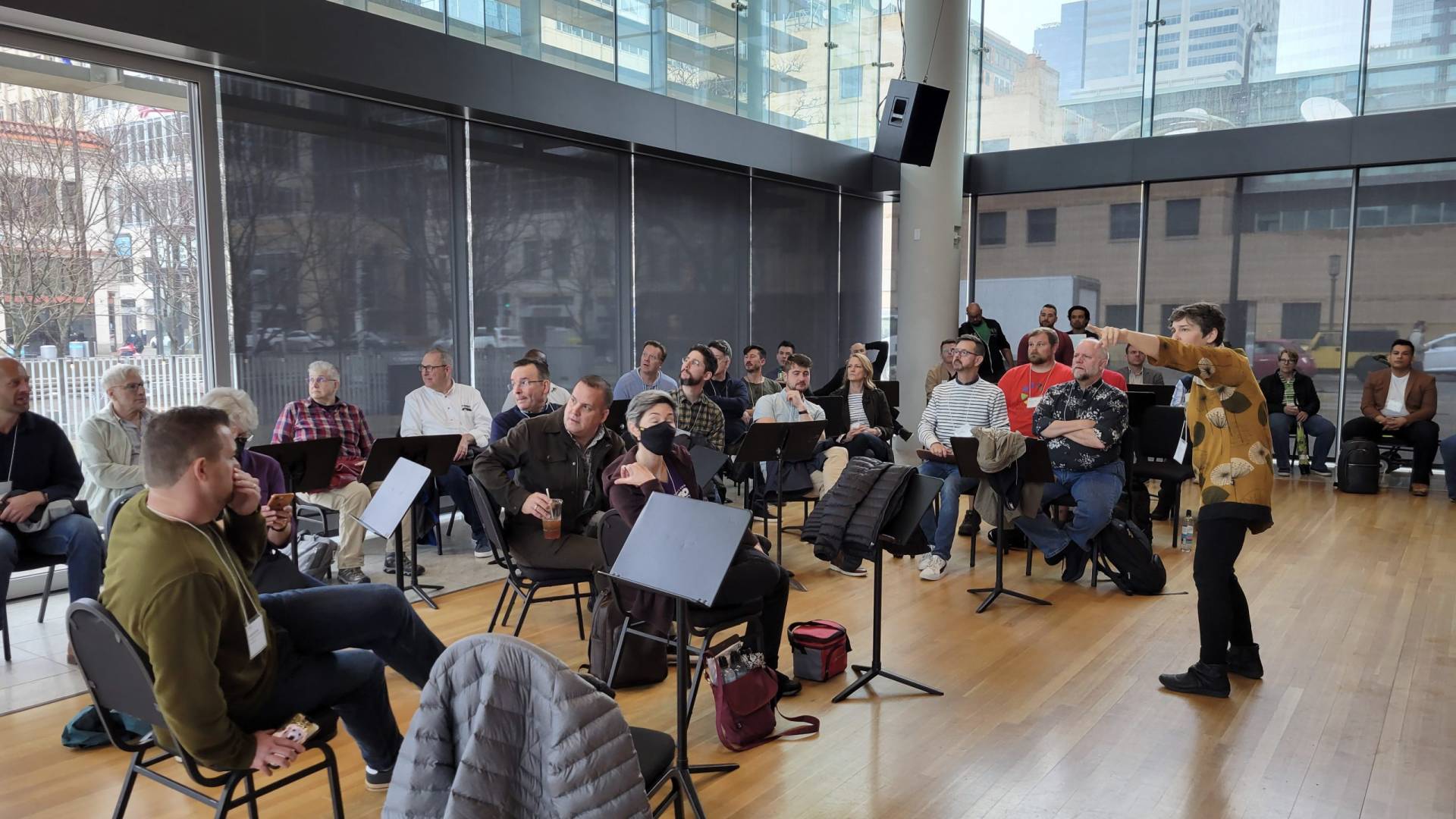 A group of Artistic Directors sit in a brightly lit room in Orchestra Hall in Minneapolis.